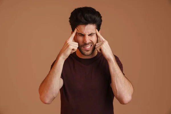 Displeased Young Man Headache Rubbing His Temples Isolated Beige Background — Stock Photo, Image