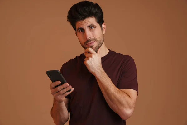 Pleased Masculine Man Using Mobile Phone While Looking Camera Isolated — Stock Photo, Image