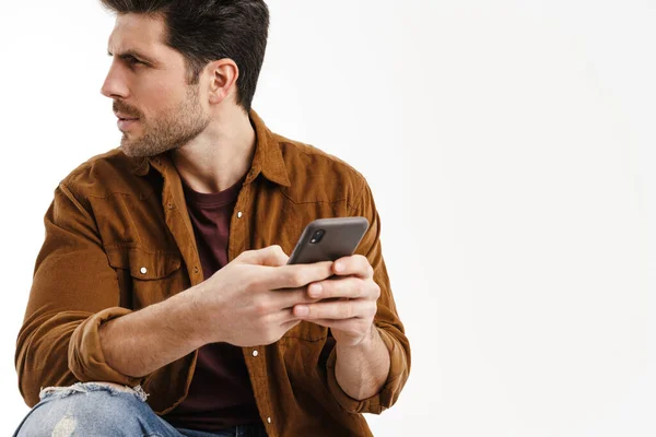 Masculine Brooding Man Looking Aside While Using Cellphone Isolated White — Stock Photo, Image