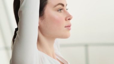 Kollarını kaldıran bir kadının yan görüntüsü.