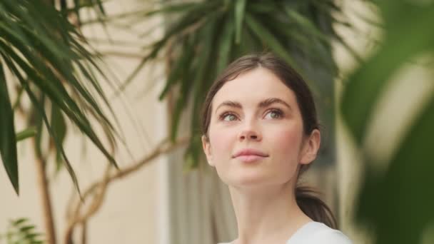 Close Shot Smiling Woman Touching Palm Leaves Looking — Stock Video