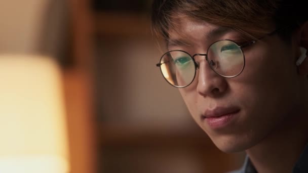 Close View Smiling Asian Man Eyeglasses Looking While Sitting Night — Stock Video