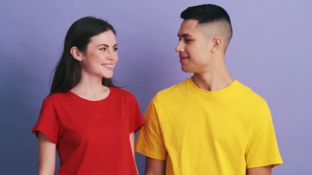 Gülümseyen Çift Mor Stüdyoda Dururken Birbirlerini Öpüyorlar — Stok video