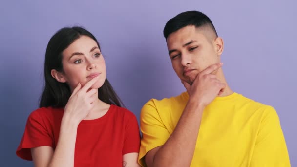 Pensive Couple Thinking Something Bringing Hand Face While Standing Purple — Stock video