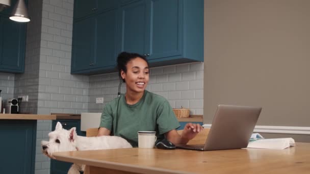 Smiling African American Woman Petting Dog While Sitting Kitchen Home — Stock video