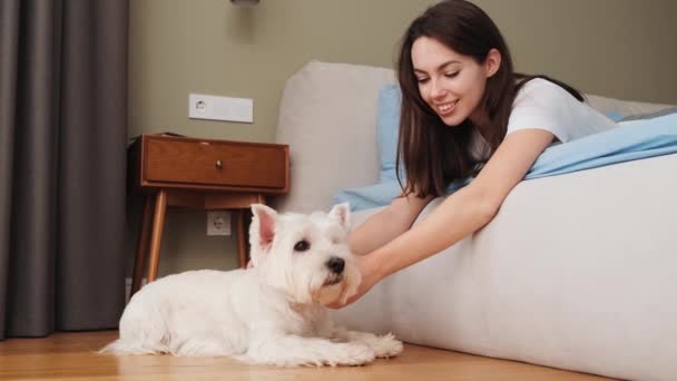 Smiling Girl Petting Dog While Lying Bed Home — ストック動画