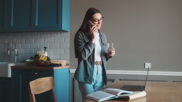 Smiling Woman Glasses Talking Phone While Standing Table Laptop Kitchen — 비디오