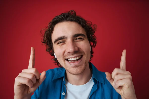Χαρούμενος Όμορφος Άντρας Ακουστικά Που Δείχνει Δάχτυλα Προς Πάνω Απομονωμένος — Φωτογραφία Αρχείου