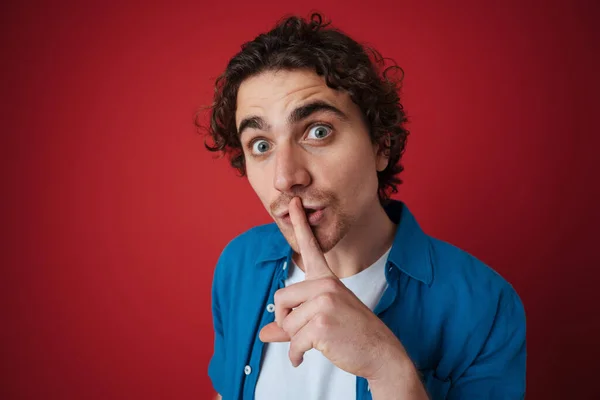 Surprised Handsome Man Showing Silence Gesture Camera Isolated Red Background — Stock Photo, Image