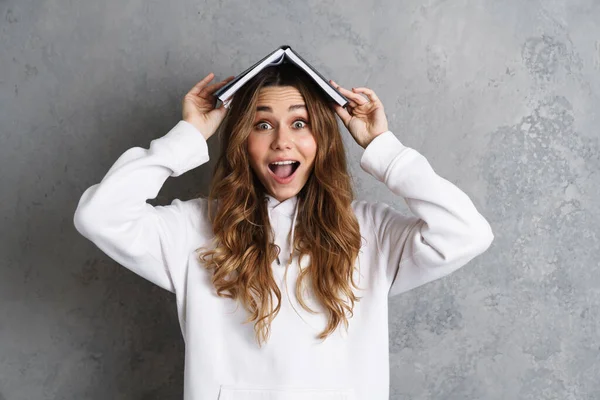 Beautiful Lovely Young Girl Holding Book Her Head Isolated Gray — Stock Photo, Image