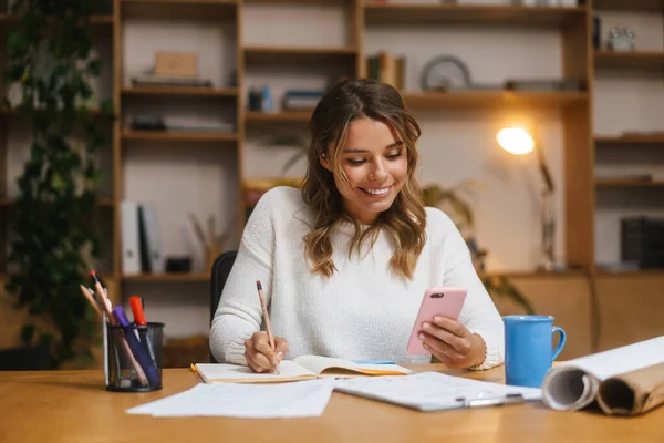 Smiling Attractive Young Woman Entrepreneur Using Mobile Phone While Working — Stock Photo, Image