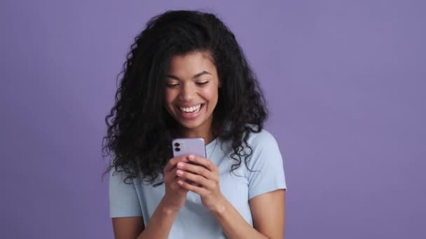 Laughing African Curly Haired Woman Shirt Looking Phone Purple Studio — Stock Video