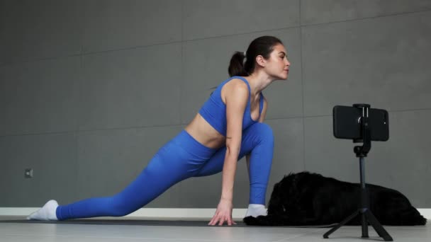 Una Deportista Guapa Está Grabando Vídeo Mientras Estira Sentada Esterilla — Vídeos de Stock