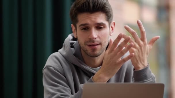 Young Man Hoodie Looking Emotionally Laptop Wrinkling His Forehead While — Stock Video