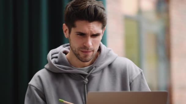 Pensive Young Man Hoodie Thinking What Write Notebook While Looking — Stock Video