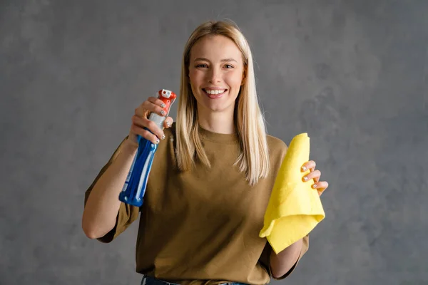 Mulher Loira Feliz Empregada Segurando Garrafa Detergente Pano Pulverizando Vidro — Fotografia de Stock