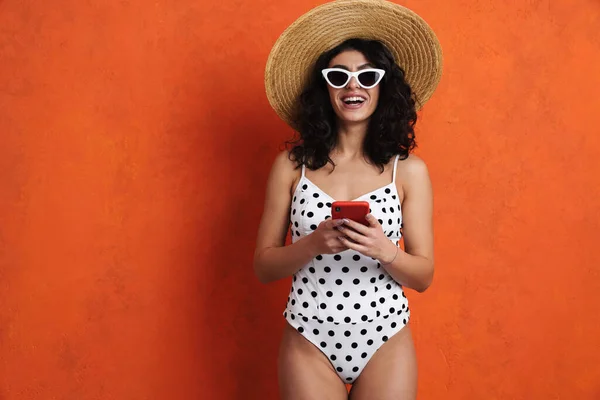 Joyful Beautiful Woman Swimsuit Smiling While Using Cellphone Isolated Orange — Stock Photo, Image