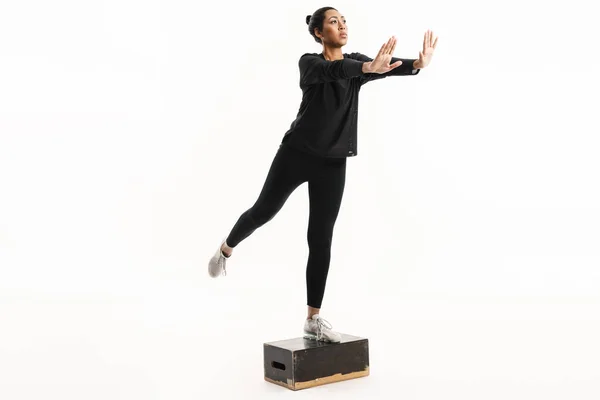 Afro American Sportswoman Outstretched Hands Jumping Wooden Fitness Block Isolated — Stock Photo, Image