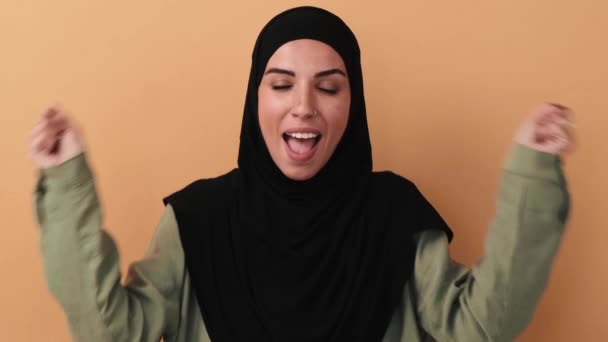 Happy Arabian Woman Wearing Black Hijab Rejoicing Standing Isolated Beige — Stock Video