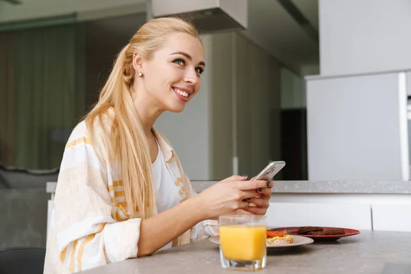 Возбужденная Женщина Помощью Мобильного Телефона Время Завтрака Домашней Кухне — стоковое фото
