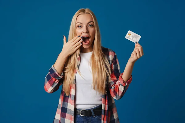 Blond Förvånad Kvinna Utropar Samtidigt Visar Kreditkort Isolerad Över Blå — Stockfoto