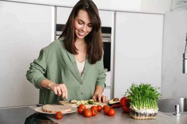 Joyful Brunette Woman Smiling While Preparing Sandwich Avocado Home Kitchen — Stock Photo, Image