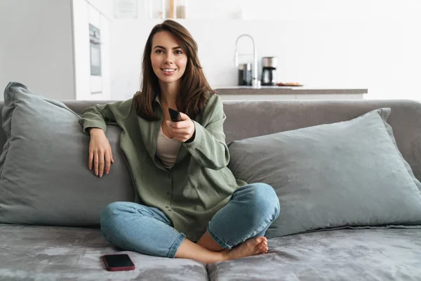 Happy Young Woman Watching Sofa Holding Remote Control — Stock Photo, Image