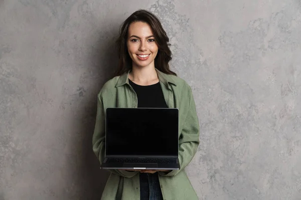 Happy Beautiful Nice Girl Smiling Showing Laptop Isolated Grey Wall — Stok Foto