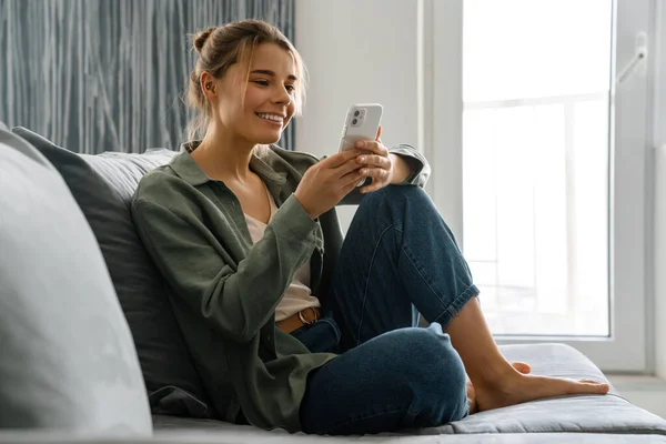 Glückliche Schöne Frau Mit Handy Während Sie Hause Auf Dem — Stockfoto
