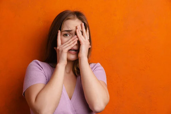 Young Ginger Scared Woman Looking Camera While Covering Her Face — 스톡 사진