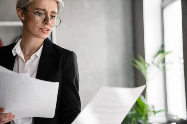 White Haired Puzzled Woman Working Papers While Standing Office — Stock Fotó