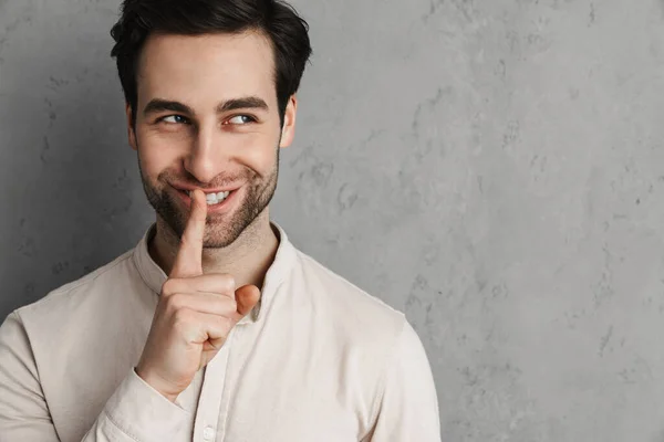 Happy Young Man Asking Silence Gesturing His Finger Isolated Gray - Stock-foto