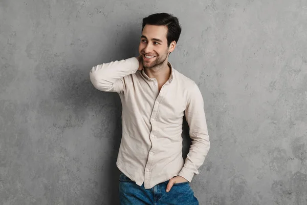 Joyful Handsome Unshaven Guy Smiling Looking Aside Isolated Grey Wall — Stock Fotó