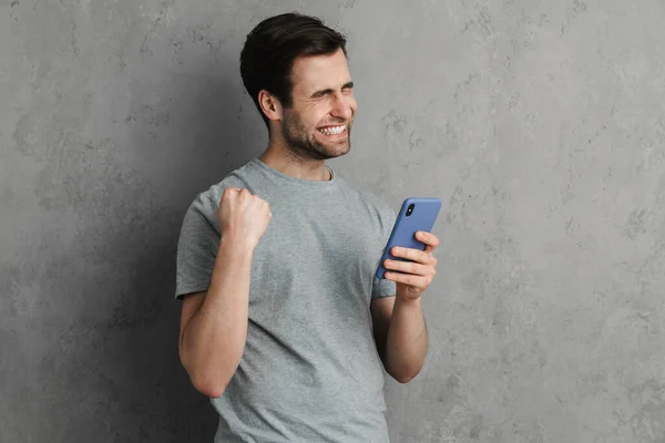 Portrait Confident Happy Man Holding Mobile Phone Celebrating Success Isolated — Stock Photo, Image
