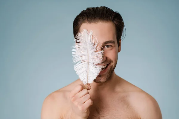 Atractivo Joven Sonriente Hombre Desnudo Tocando Cuerpo Con Una Pluma —  Fotos de Stock