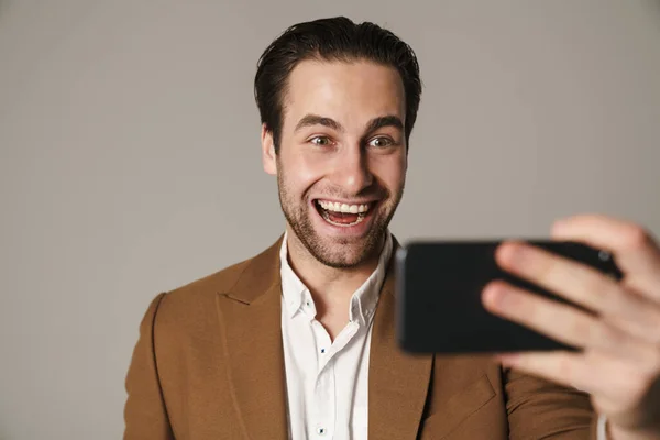 Unshaven Excited Man Smiling Taking Selfie Cellphone Isolated Grey Background — Stock Photo, Image