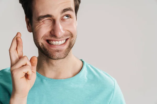 Jongeman Maakt Een Wens Geïsoleerd Grijze Achtergrond Vingers Gekruist Close — Stockfoto