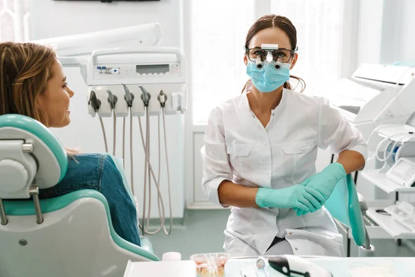 歯医者で働いている間に顕微鏡を使用して顔のマスクのヨーロッパのミッド歯医者の女性 — ストック写真