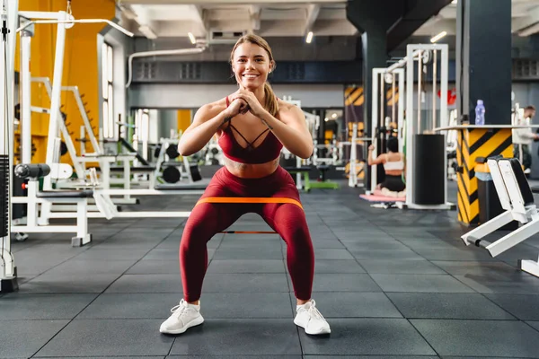 在健身房锻炼的同时 带着膨胀机做运动的女运动员 — 图库照片