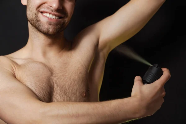 Guapo Sonriente Hombre Sin Camisa Rociando Desodorante Aislado Sobre Fondo —  Fotos de Stock