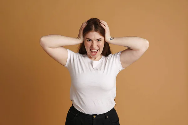 Joven Mujer Irritada Gritando Mientras Sostiene Cabeza Aislada Sobre Pared —  Fotos de Stock