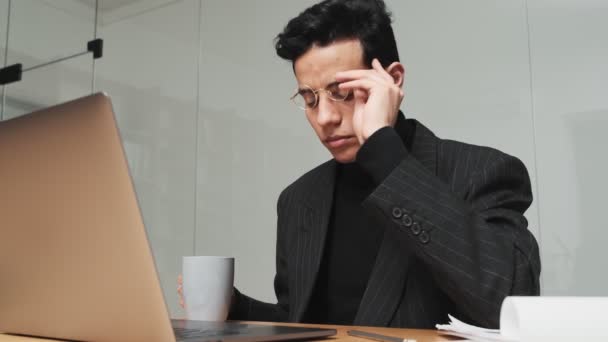 Een Denkende Arabische Man Werkt Met Zijn Laptop Terwijl Hij — Stockvideo
