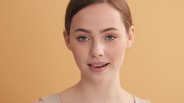 Positive Woman Licking Her Teeth Standing Isolated Beige Wall Studio — Stock Video