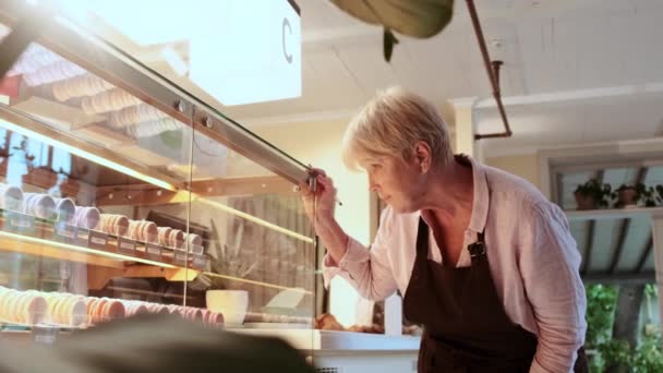 Serious Woman Cafe Worker Checks Shop Window Cakes Cafe — Stock Video