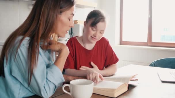 Happy Young Girl Syndrome Reading Book While Adult Woman Helping — Stock Video