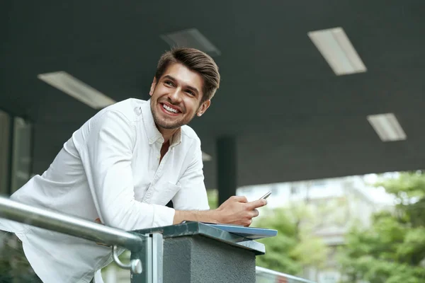 Pleased European Businessman Holding Mobile Phone Documents Young Man Standing Stock Picture