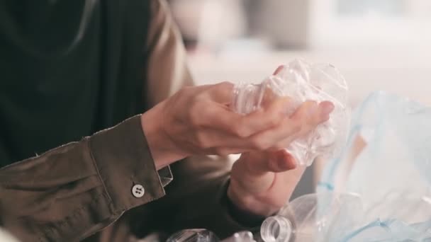 Beautiful Arabian Woman Wearing Hijab Squeezing Bottles While Sorting Plastic — Stock Video