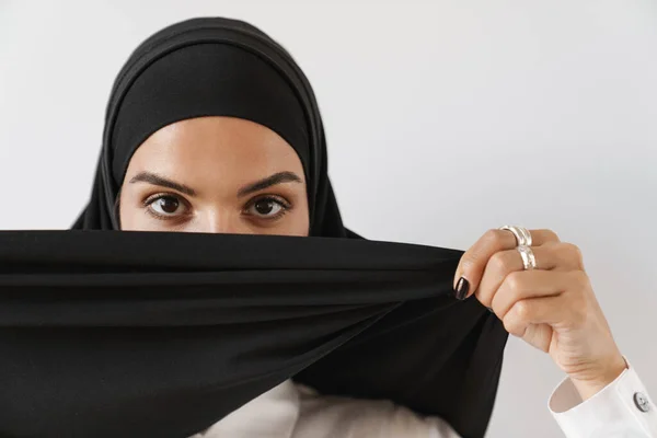 一个集中的穆斯林妇女站在白人演播室里用头巾盖住脸的画像 — 图库照片