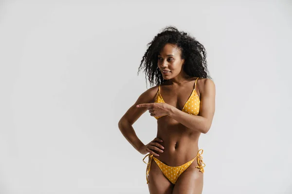 Black Woman Swimsuit Smiling Pointing Finger Aside Isolated White Background — Stock Photo, Image