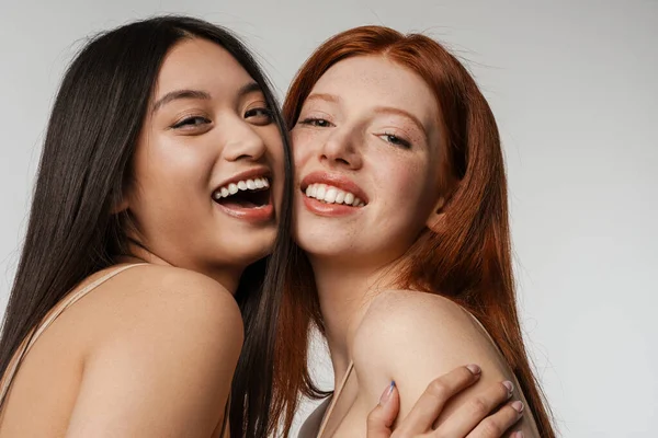 Multirracial Duas Mulheres Abraçando Rindo Câmera Isolada Sobre Parede Branca — Fotografia de Stock